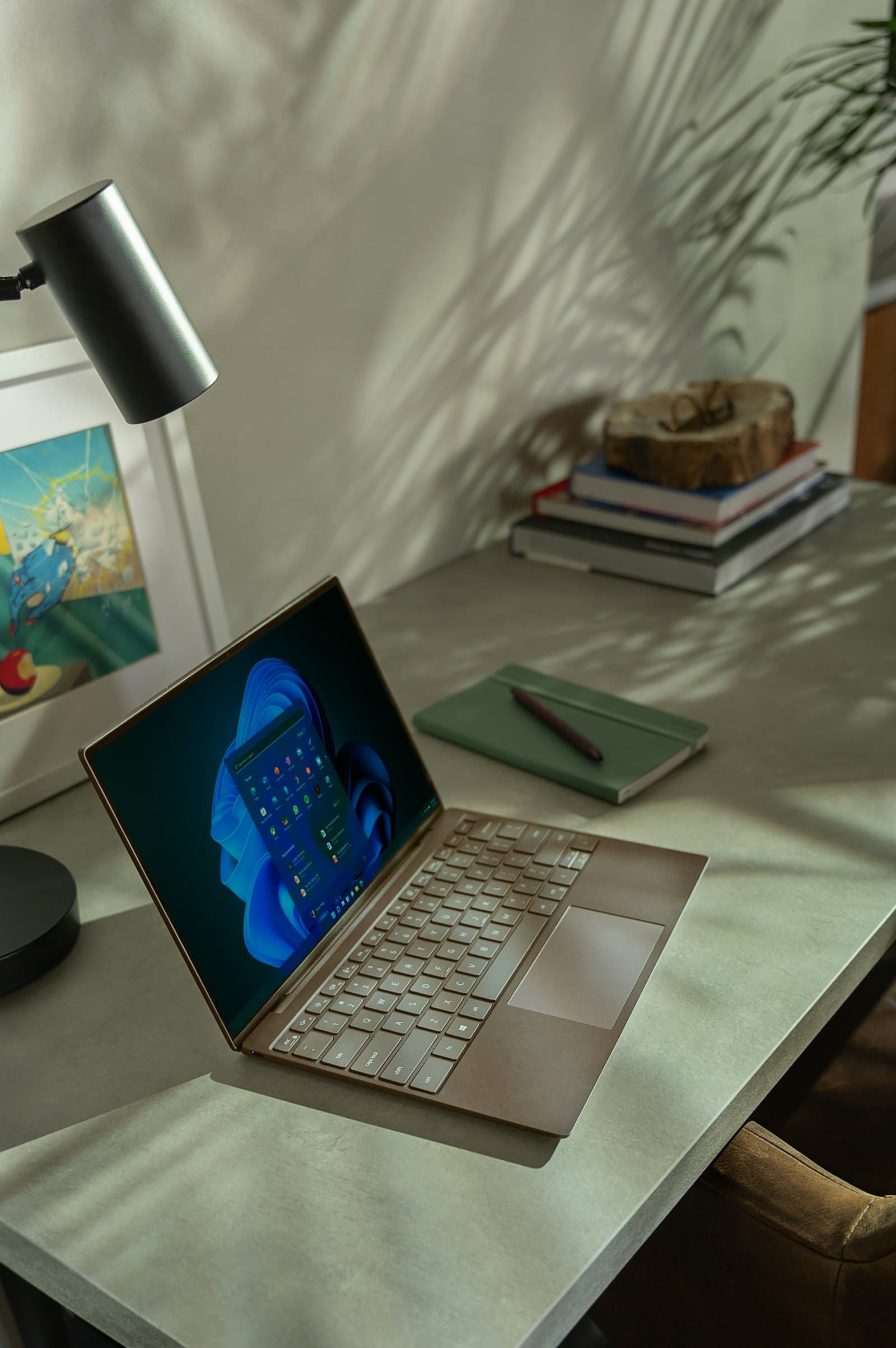 A laptop and notebook on a desk